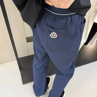 Navy fleece joggers worn with a dark jacket, photographed full length